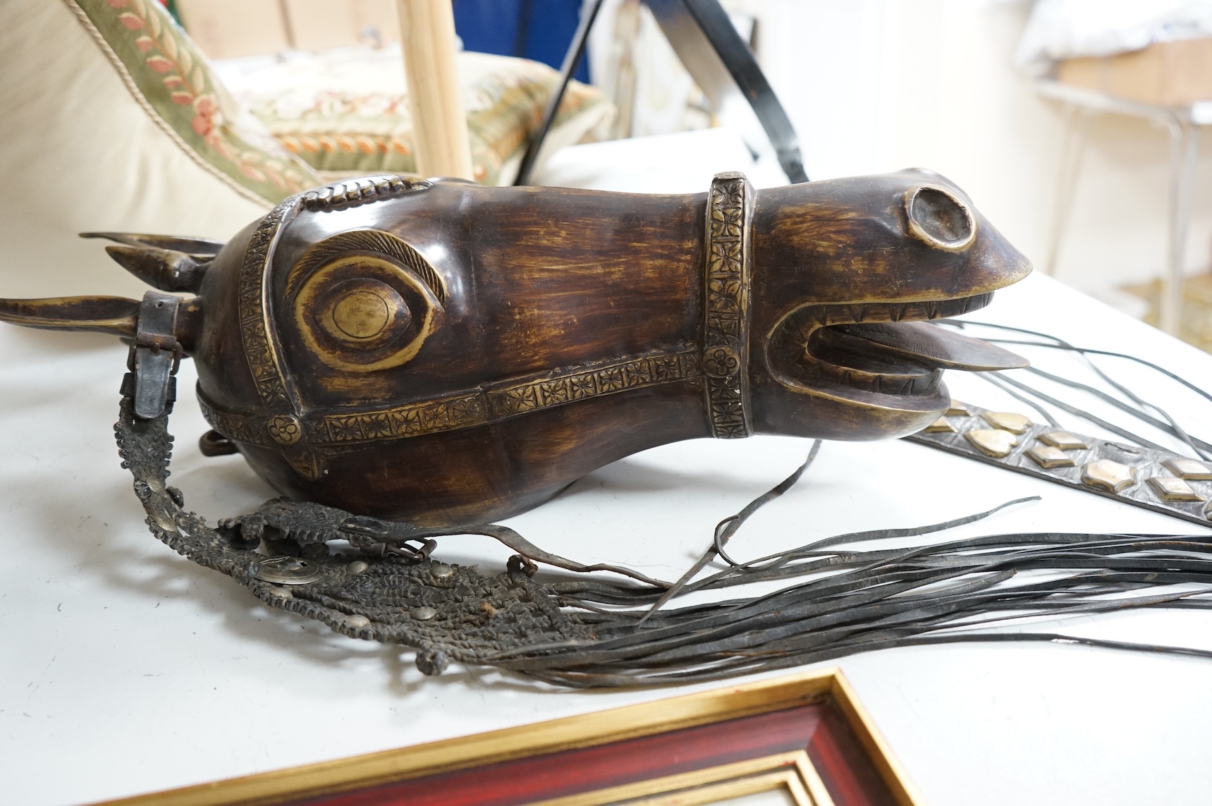 A bronze model horse’s head with martingale hanging, 55cm high